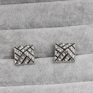 Square silver geometric cufflinks with black enamel grid and sparkling rhinestones