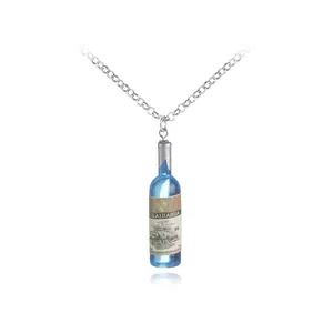 Dettaglio di un ciondolo mini bottiglia di vino blu in resina su catena argentata