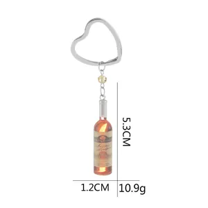Detail view of mini wine bottle keychain with heart ring and size markers 5.3x1.2cm