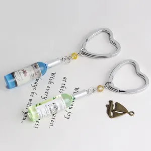 Creative resin beer bottle keychain with heart ring and blue or green liquid detail