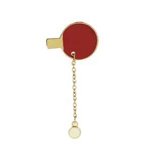 Detail of red table tennis racket brooch with gold plating and white ball pendant