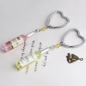 Detail of heart-shaped metal keychains with realistic miniature resin beer bottle charms