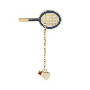 Detailed view of enamel badminton racket brooch with golden chain and shuttlecock charm