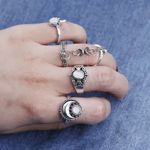 Bohemian vintage silver ring set with moon design and white opal stones on denim