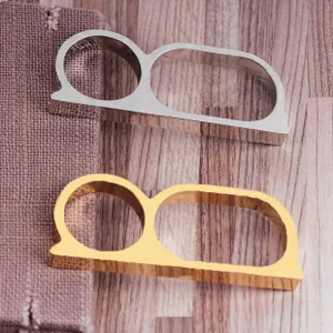 Detail view of gold and silver double-finger geometric rings on a rustic fabric background