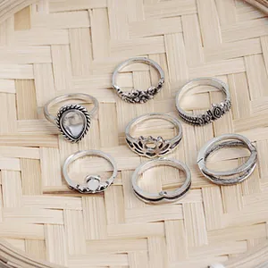 Detailed view of 7-piece vintage silver heart ring set with antique floral carvings