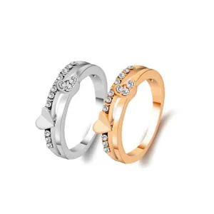 Macro shot of silver and rose gold heart rings with pave cubic zirconia accents