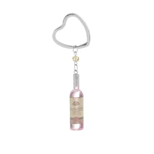 Portachiavi a bottiglia di vino rosa in resina con anello a cuore e perla