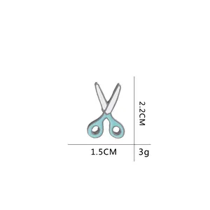 Detailed size view of a light blue enamel scissor brooch, dimensions 2.2CM by 1.5CM
