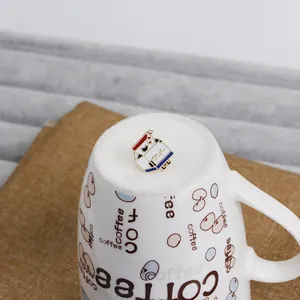 Detail of cute milk carton enamel pin with red and blue accents on a coffee mug