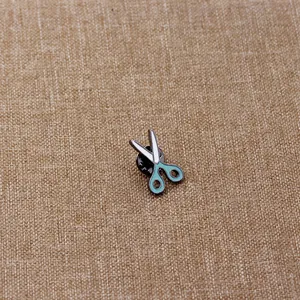 Cute cartoon enamel scissors brooch with light blue handles and silver blade detail
