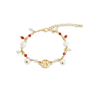 Detail of Best Friend bracelet featuring gold pentagram charm, faux pearls and red beads
