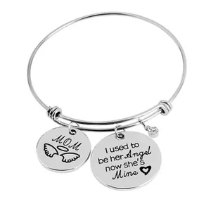 Detail of adjustable silver bangle with MOM charm and engraved memorial angel quote