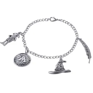 Macro view of vintage silver chain bracelet with feather and magic hat charms