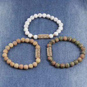 Detailed macro view of natural stone beaded bracelets with rose gold Powerful charms