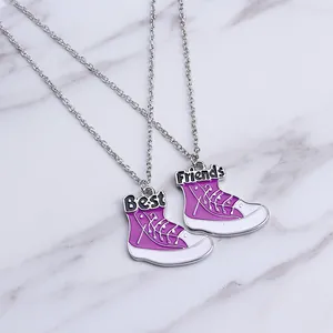 Pair of Best Friends necklaces featuring purple high-top sneaker pendants with engraving