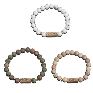 Detailed macro of natural stone bead bracelets with engraved Powerful metal plaques