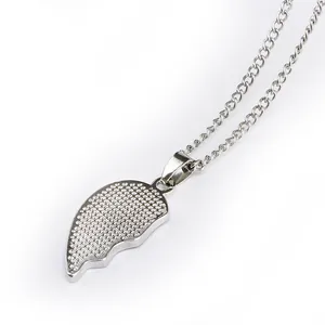 Close-up of silver-tone half-heart pendant necklace with shimmering pavé set crystals