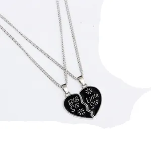 Big and Little Sister matching split heart pendant necklaces in silver and black enamel
