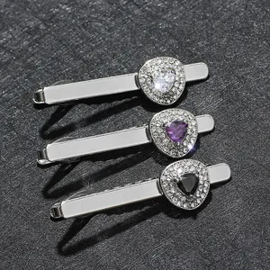 Three silver-tone necktie clips with zircon heart inlay in white, purple and black