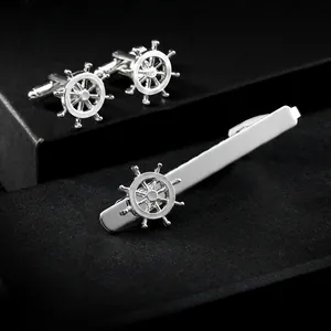 Polished silver business tie clip and cufflinks set with nautical ship helm design