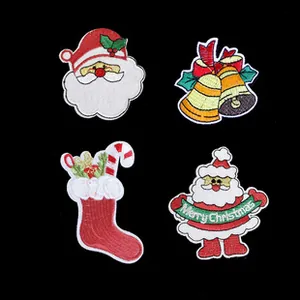 Detailed view of Christmas embroidered patches with Santa Claus, bells and socks on black background