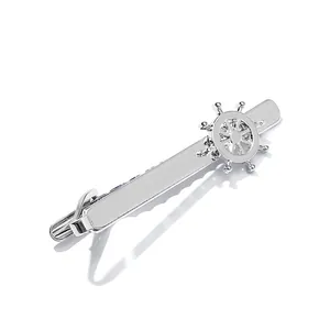 Polished silver tie clip with nautical ship wheel anchor design for formal business suit