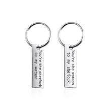 Detail of laser-engraved Sherlock and Watson heart puzzle keychains for couples