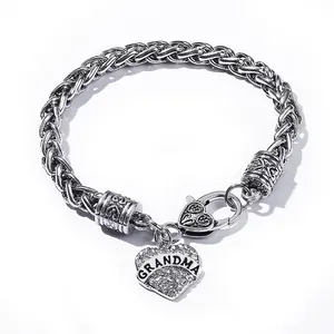 Detailed view of silver Grandma heart charm bracelet with sparkling rhinestones and woven chain