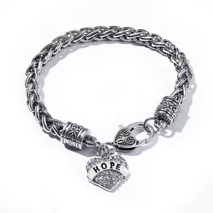 Macro shot of silver wheat chain bracelet with heart charm and HOPE lettering