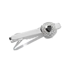 Macro shot of silver tie clip with black triangular stone and micro-pave white zircon