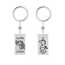 Close-up of silver keychains with unicorn engraving and Have a Magical Day text