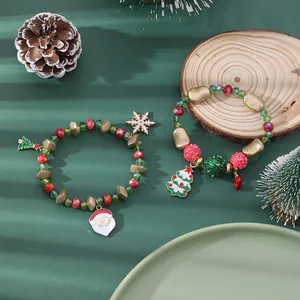 Detailed view of Christmas charm bracelets with Santa and tree enamel pendants
