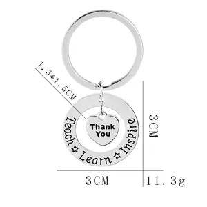 Silver stainless steel keychain with heart pendant and Teach Learn Inspire engraving