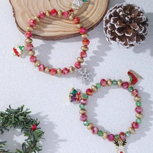Christmas beaded bracelets with Santa, reindeer and tree charms on a festive background