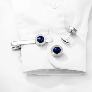 Polished silver tie clip and cufflinks set with faceted deep blue gemstone inlay