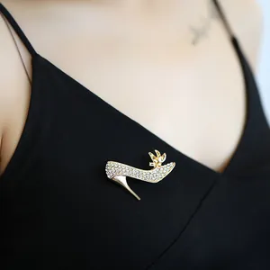 Detailed macro view of sparkling rhinestone high heel brooch on elegant black dress fabric