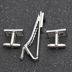 Close-up of silver business set with textured rectangular cufflinks and tie clip