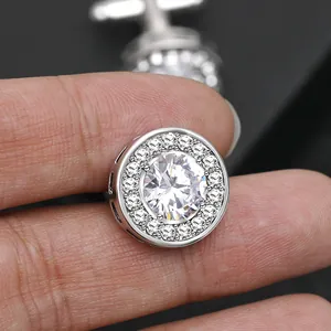 Macro shot of silver cufflinks with centered round zircon and sparkling pavé setting