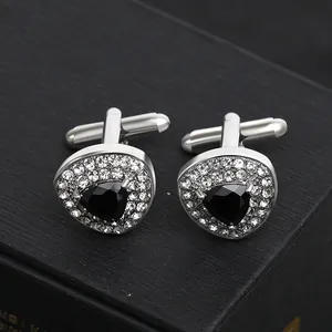 Detailed close-up of triangular black zircon cufflinks with micro-pave crystals in silver