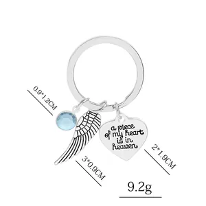 Silver wing and heart memorial keychain with engraved a piece of my heart is in heaven text