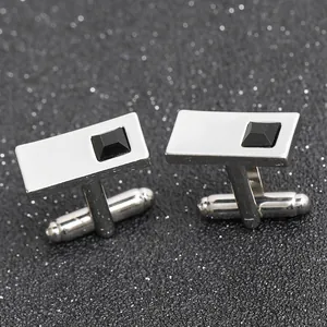 Macro detail of silver rectangular cufflinks with black stone inlay and polished finish