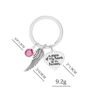 Silver heart and wing keychain with pink gemstone and sentimental engraving