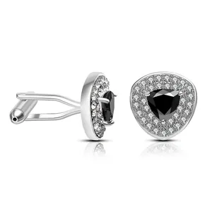 Macro detail of men's cufflinks with black triangle zircon and silver metal finish