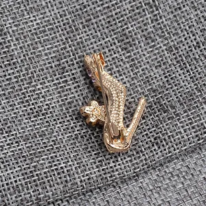Macro detail of high heel brooch with purple rhinestones and secure metal pin back