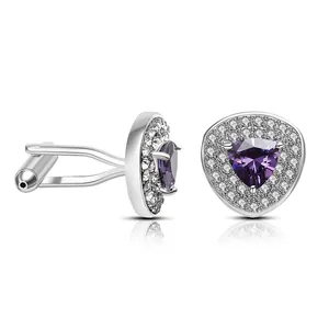 Detailed view of silver cufflinks with purple triangle zircon and pavé crystal border