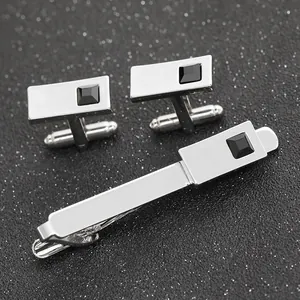 Macro shot of silver cufflink set with black square stone inlay for formal business suits