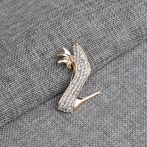 Close-up of golden alloy high heel brooch featuring detailed crystal rhinestone inlay