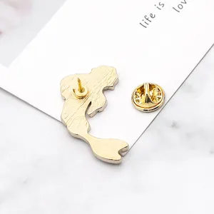 Macro shot of the golden mermaid silhouette brooch back with secure butterfly clasp pin