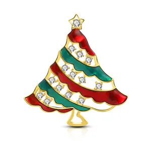 Detail of a gold Christmas tree brooch with red and green enamel and 16 sparkling zircons